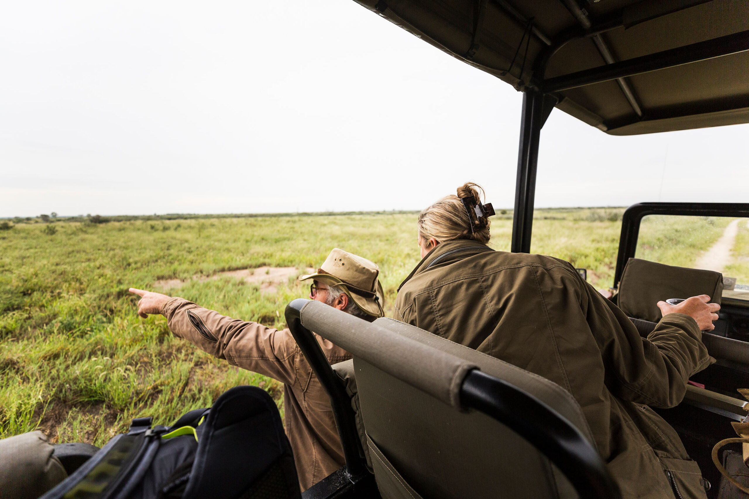 adult-woman-and-a-safari-guide-leaning-out-looking-2023-11-27-04-59-16-utc (1)